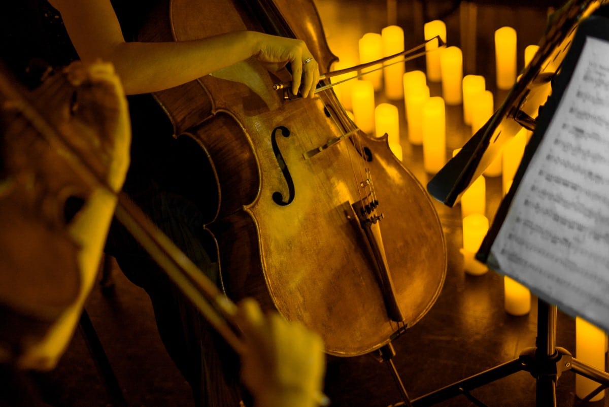 A close up of a cellist performing on stage