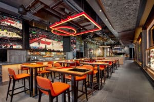 NBA Courtside Restaurant / interior photo. high top tables and bar