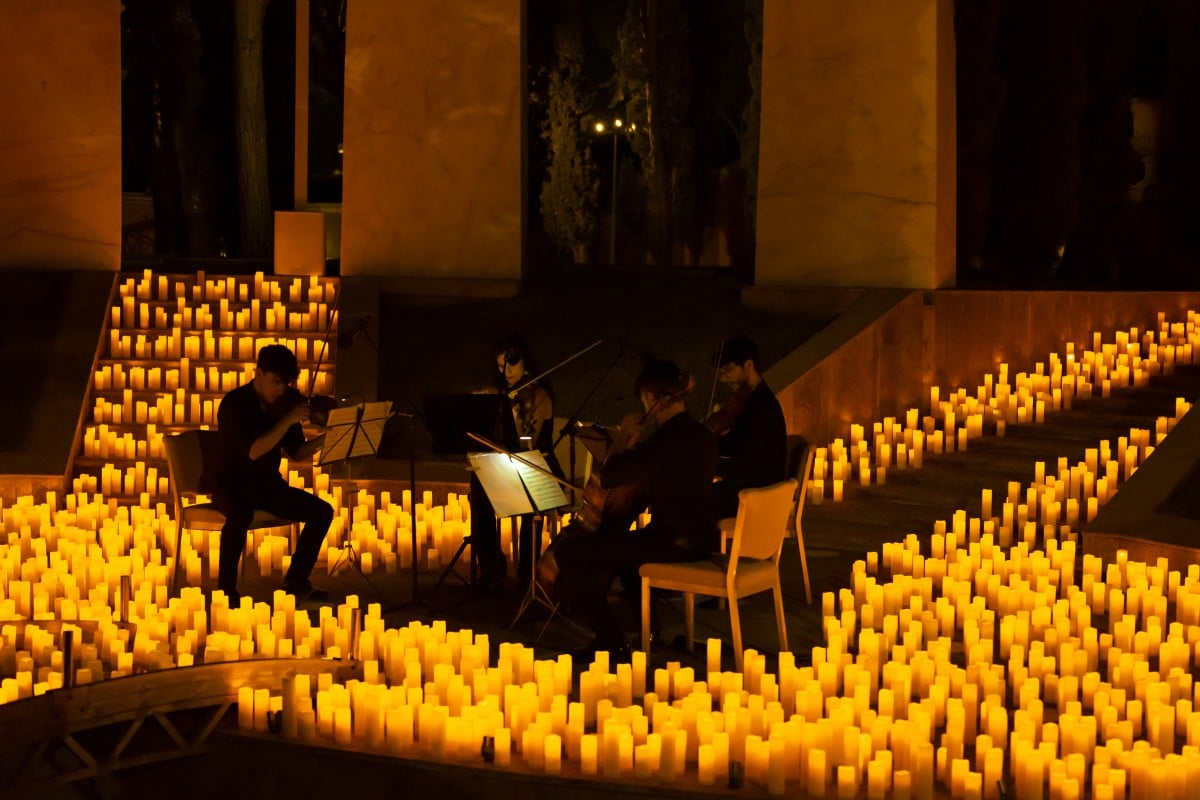 A string quartet performs in an open-air setting